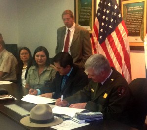 SINAC Executive Director Rafael Guitiérrez, center, Christopher Stein, right, superintendent of St. Croix National Scenic Riverway in the U.S., and Osa Conservation Area Director Etilma Morales sign a sister park agreement between the Osa Conservation Area and the national parks of the upper Midwest of the United States. (Photo by Judy Freund, Rotary District 5960)