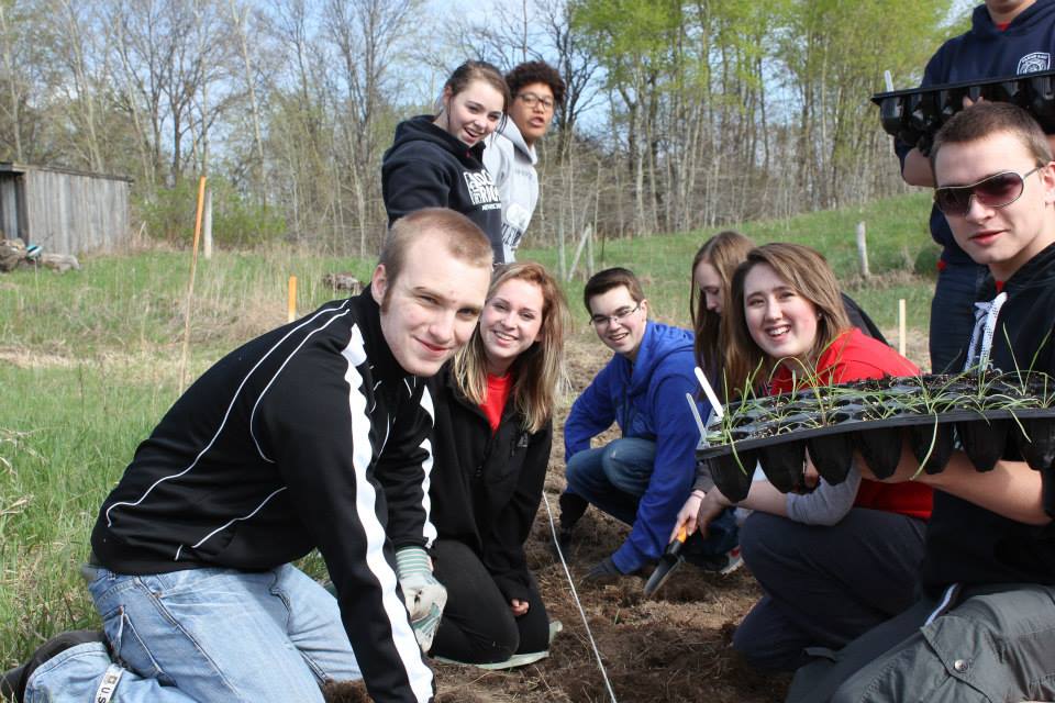 Students plant Dotted-Blazing Star seeds saved from the site of the new Stillwater Bridge. The endangered plant's species is 8,000 years old.