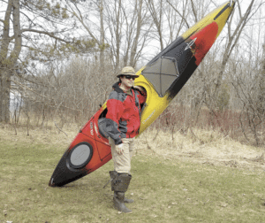 Kyle Weaver with his new kayak, Sans Souci II, named after Eric Sevareid's canoe from the classic book 'Canoeing with the Cree,' and which means "carefree" in French