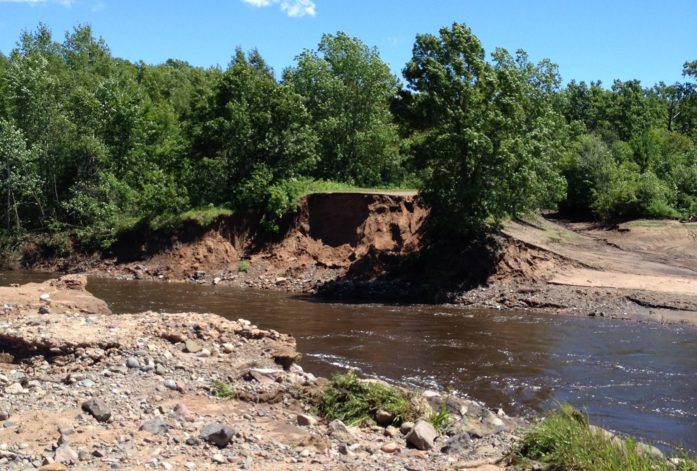 The Totogatic River found a new route out of the Colton Flowage – through the road. (Photo by Joyce Palucci)