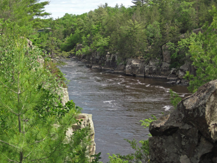 The view of the river shown above is from Angle Rock, a significant rocky promontory that marks the upstream end of a fault-controlled jog in the course of the St. Croix River. (Photo and caption by James St. John)
