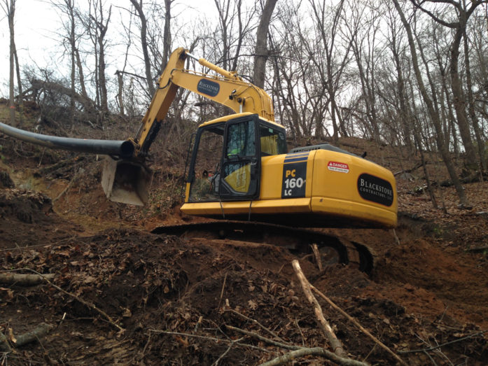 Installing the massive plastic pipe. (Photo courtesy Carnelian-Marine-St. Croix Watershed District)