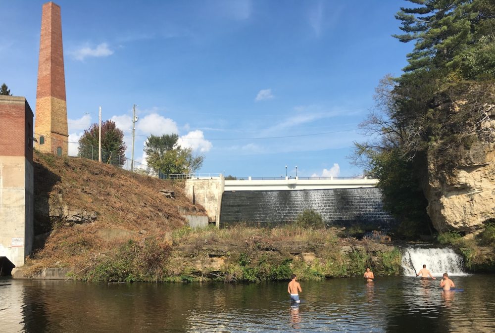 Children swimming below a dam in River Falls, Wisconsin